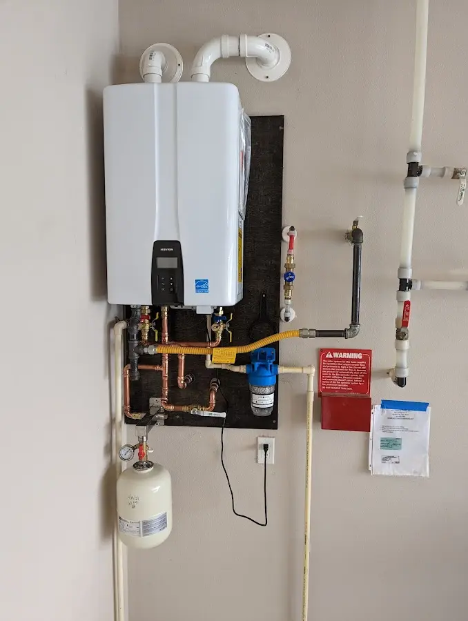 Professional plumber installing copper piping in a Wyoming home